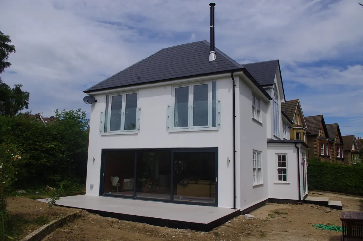 White rendered house with a two-storey rear extension