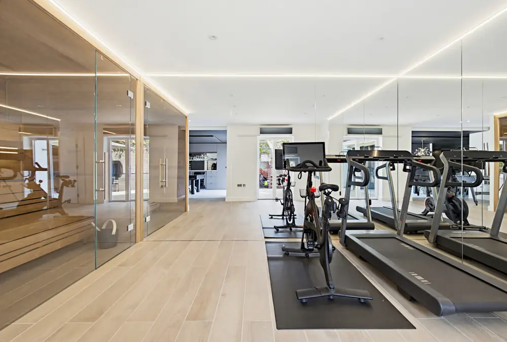 Home gym with a timber-lined sauna in a Hampstead extension