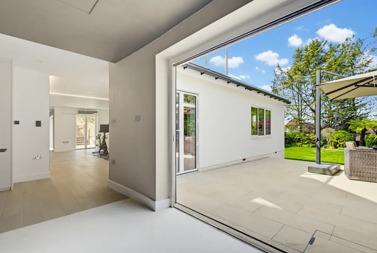 Garden room with full-height sliding glass doors in Hampstead